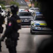 Police guard the area as a convoy brings the suspect in shooting of Slovakia’s Prime Minister Robert Fico, to court in Pezinok (Tomas Benedikovic/AP)