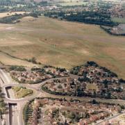 A view of the airfield showing the A41 dual carriageway (bottom left to middle left) with Ashfields road bridge. The roundabout junction exits are High Road and A405. The oval green area of Macdonnell Gardens can also be seen