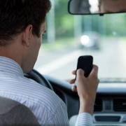 The 37-year-old was found guilty of using his phone on the motorway near Watford.