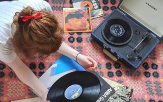 Photo of a music lover listening to a record player. Photo via Natasha Meek/Newsquest.