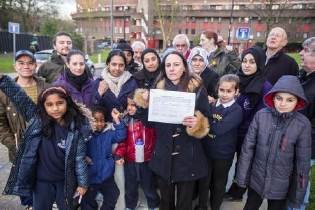 Shona Perkins holding petition with Strawberry Vale residents during the problems in 2016